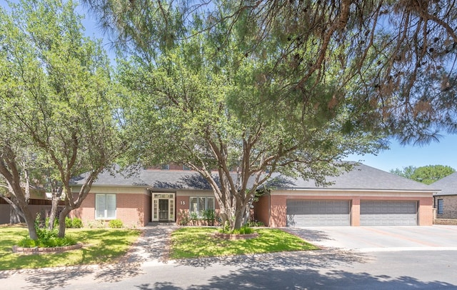 15 Lakes Dr, Midland, TX 79705 - view of front of property featuring driveway, an attached garage, and brick siding