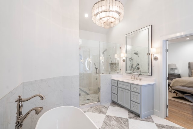 15 Lakes Dr, Midland, TX 79705 - bathroom with ensuite bath, a marble finish shower, vanity, a freestanding bath, and a chandelier
