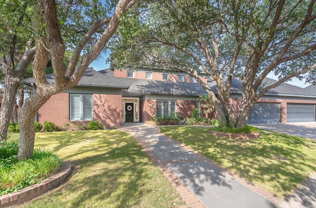 15 Lakes Dr, Midland, TX 79705 - traditional-style home featuring brick siding, a front yard, a shingled roof, and a garage