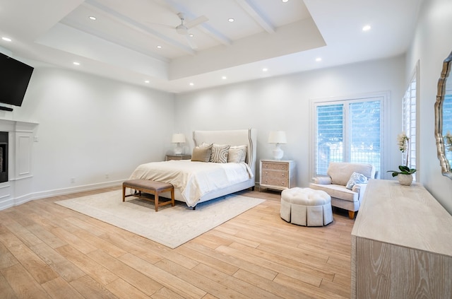 15 Lakes Dr, Midland, TX 79705 - bedroom with light wood-type flooring, beamed ceiling, recessed lighting, a fireplace, and ceiling fan