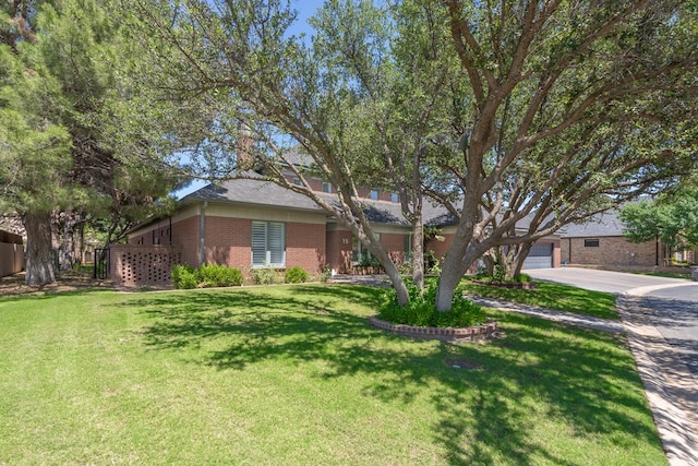 15 Lakes Dr, Midland, TX 79705 - view of front of property with brick siding, a front yard, and a garage