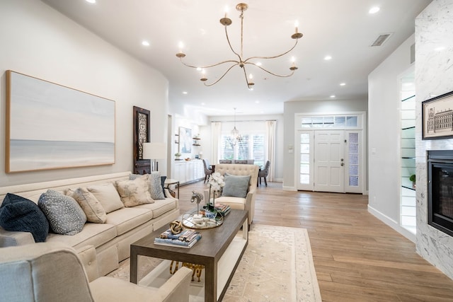 15 Lakes Dr, Midland, TX 79705 - living room with a chandelier, light wood finished floors, recessed lighting, and a large fireplace