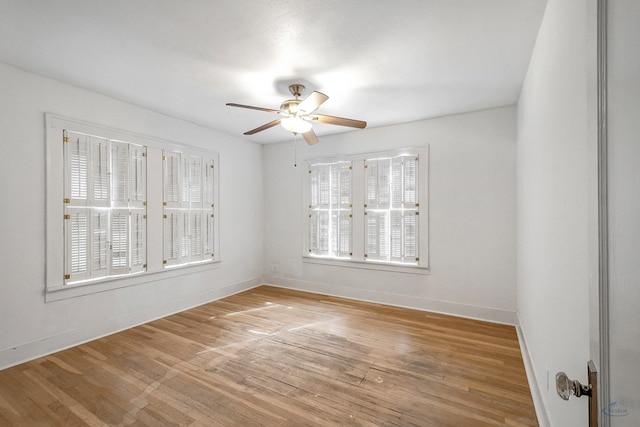 unfurnished room featuring ceiling fan, a wealth of natural light, and hardwood / wood-style flooring