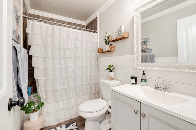 bathroom with vanity, ornamental molding, curtained shower, toilet, and a wainscoted wall
