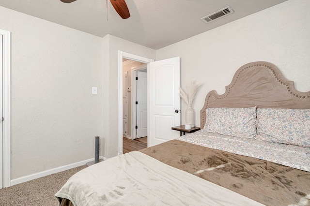 bedroom with visible vents, a ceiling fan, baseboards, and carpet floors