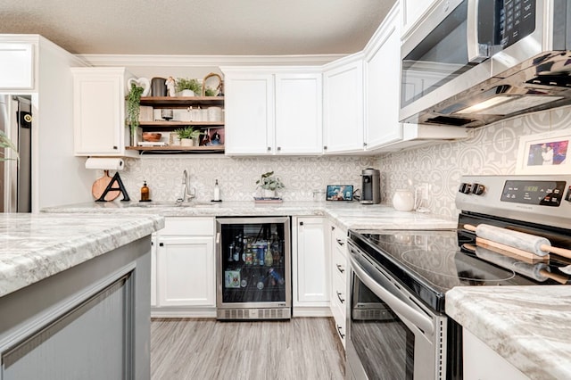 kitchen with white cabinetry, appliances with stainless steel finishes, and wine cooler