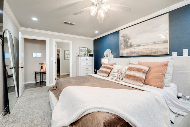 carpeted bedroom featuring recessed lighting, a ceiling fan, baseboards, visible vents, and ornamental molding