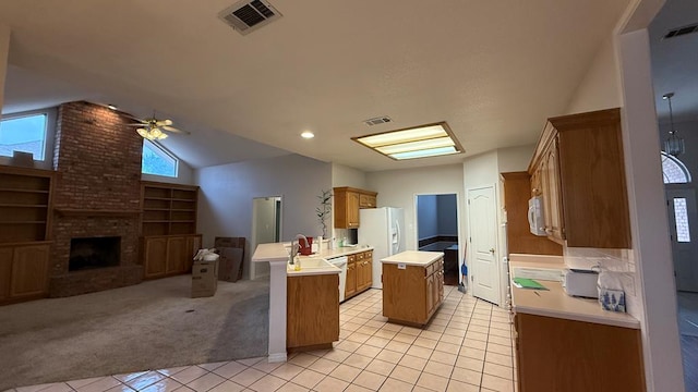 4804 Bishops Castle Dr, Midland, TX 79705 - kitchen with a peninsula, light tile patterned floors, light countertops, open floor plan, and ceiling fan