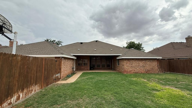 4804 Bishops Castle Dr, Midland, TX 79705 - back of property with a fenced backyard, a patio, roof with shingles, and brick siding