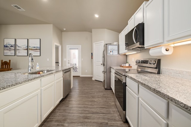 kitchen with visible vents, dark wood-style floors, white cabinetry, a sink, and stainless steel appliances