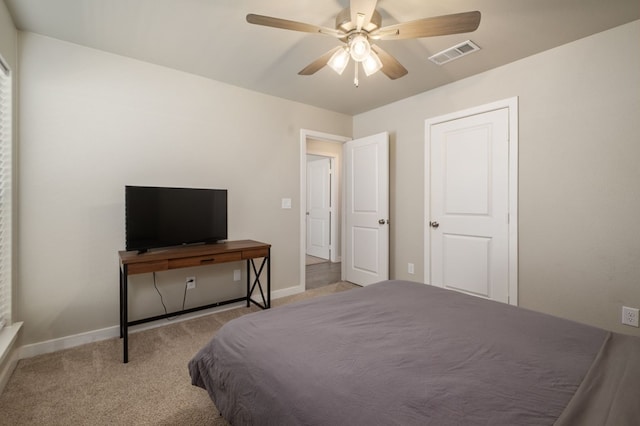carpeted bedroom featuring visible vents, a ceiling fan, and baseboards