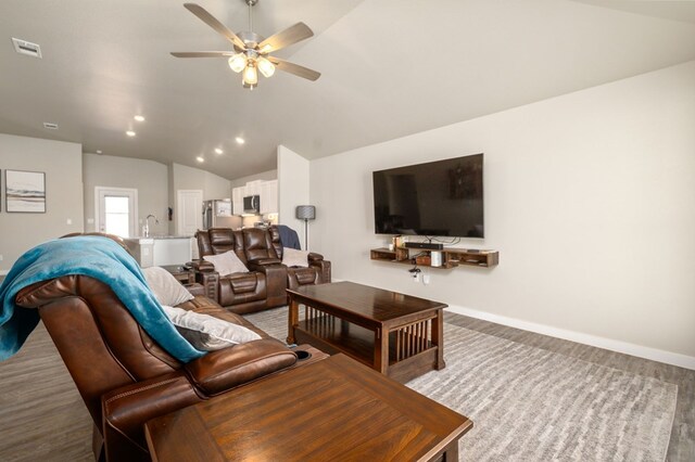 living area with ceiling fan, recessed lighting, baseboards, lofted ceiling, and visible vents