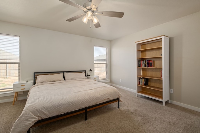 carpeted bedroom featuring baseboards and ceiling fan
