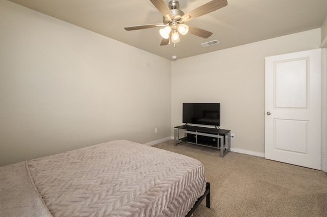 bedroom featuring baseboards, ceiling fan, light colored carpet, and visible vents