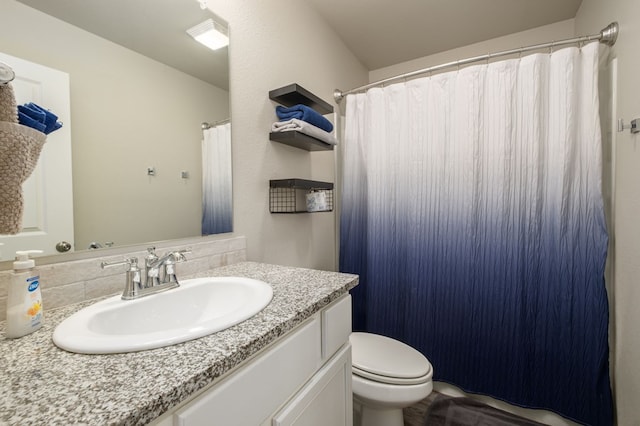 bathroom featuring toilet, curtained shower, and vanity