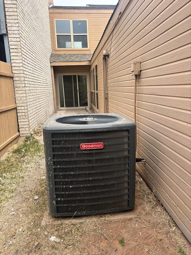 exterior details with central AC unit and fence