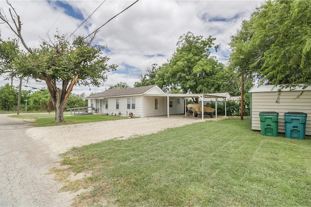 601 E 1st St, Coleman, TX 76834 - rear view of house with dirt driveway, a yard, and an attached carport