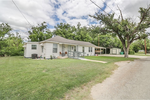 601 E 1st St, Coleman, TX 76834 - view of front of house with a shed, a front lawn, driveway, and view of wooded area
