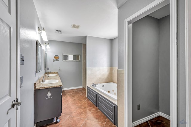 bathroom with vanity, a bath, and tile patterned floors