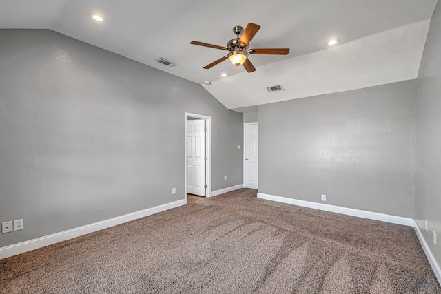 carpeted empty room featuring lofted ceiling and ceiling fan