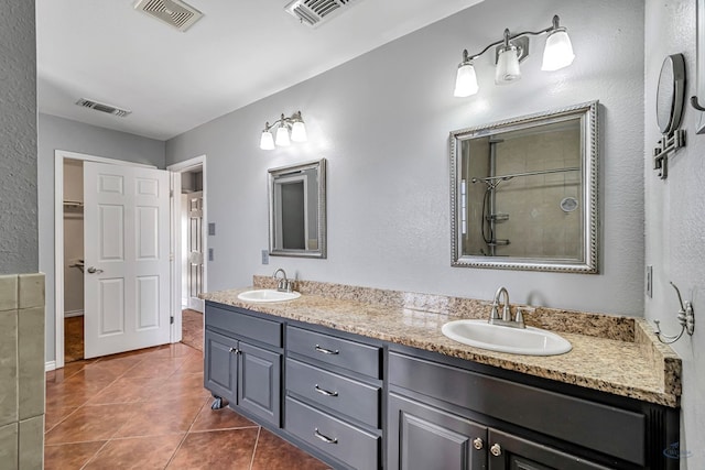 bathroom with tile patterned floors, vanity, and a shower