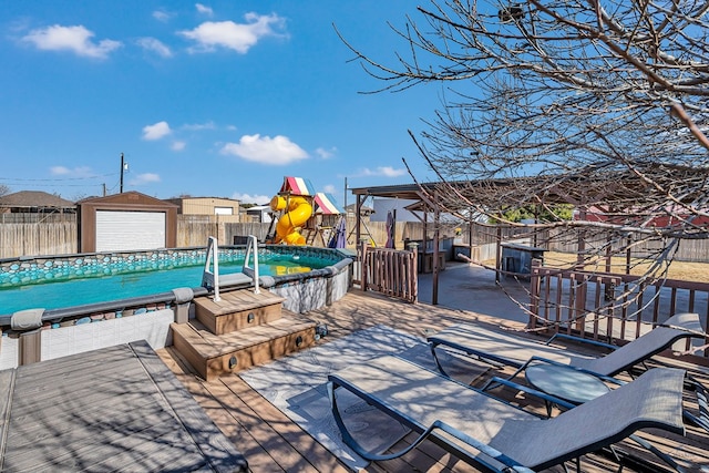 wooden deck with a fenced in pool