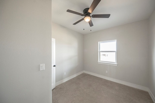 carpeted spare room featuring ceiling fan