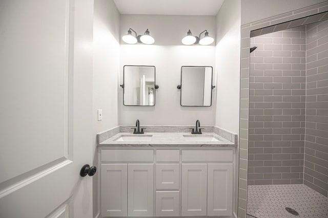 bathroom featuring vanity and tiled shower