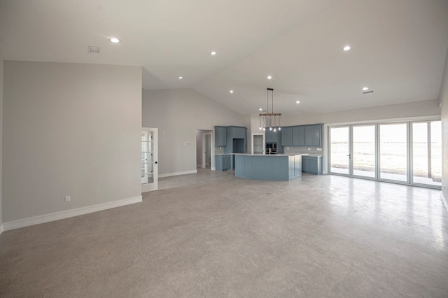 unfurnished living room with high vaulted ceiling and light colored carpet