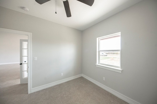 carpeted spare room with ceiling fan