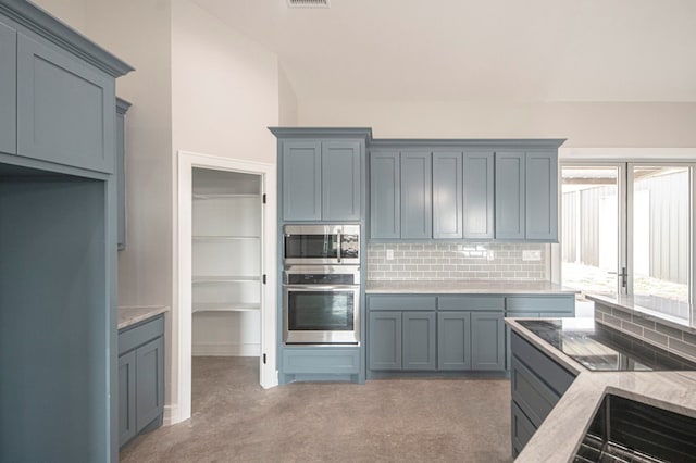 kitchen with decorative backsplash and stainless steel appliances