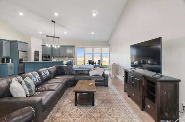 living room with high vaulted ceiling and an inviting chandelier