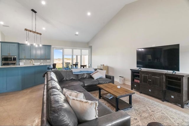 living room featuring light colored carpet, high vaulted ceiling, and sink