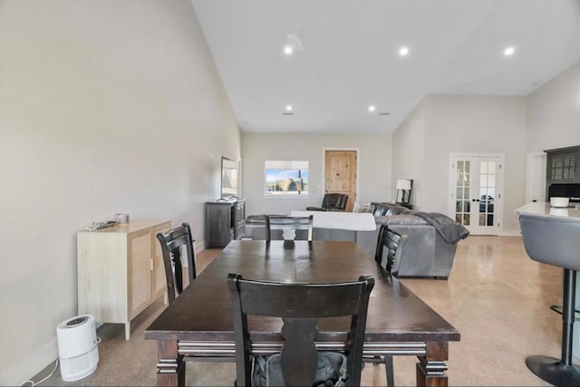 dining room featuring french doors and a towering ceiling