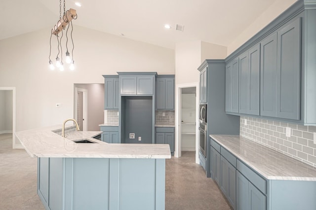 kitchen featuring backsplash, light carpet, sink, and pendant lighting