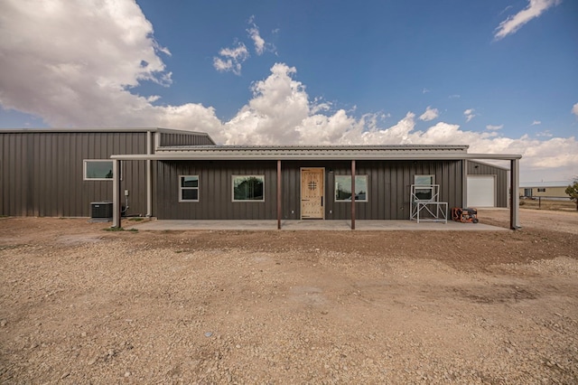 view of front of property featuring cooling unit and a garage