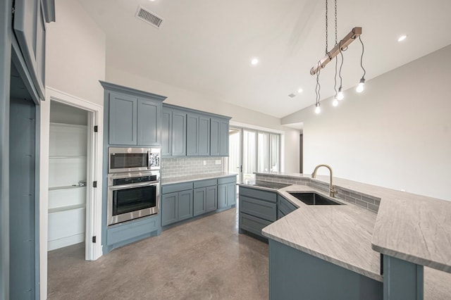 kitchen with sink, stainless steel appliances, backsplash, pendant lighting, and vaulted ceiling