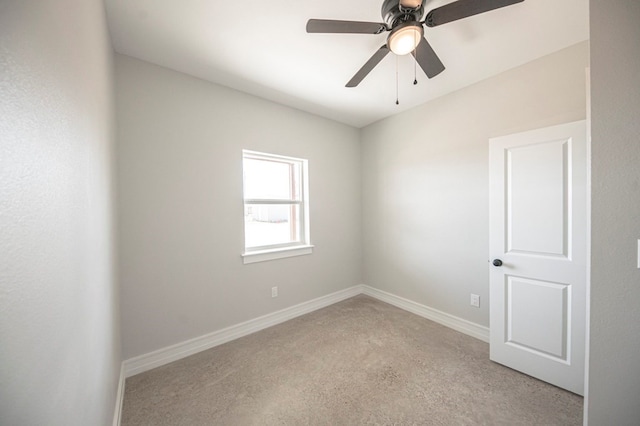 spare room featuring light colored carpet and ceiling fan