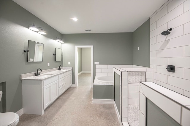 bathroom featuring a tub, vanity, and toilet