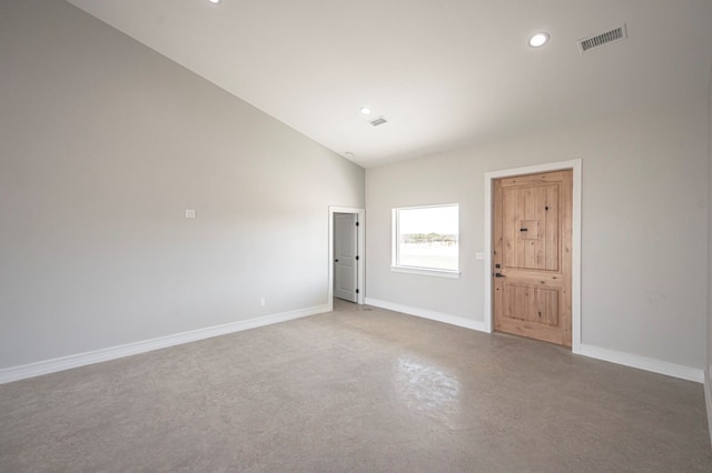 unfurnished room featuring lofted ceiling