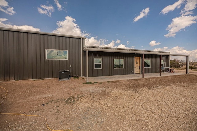 view of front of property with central AC and a patio area