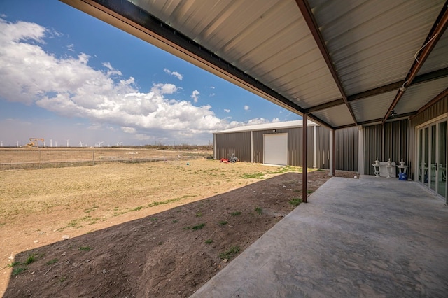 view of yard featuring an outbuilding and a rural view