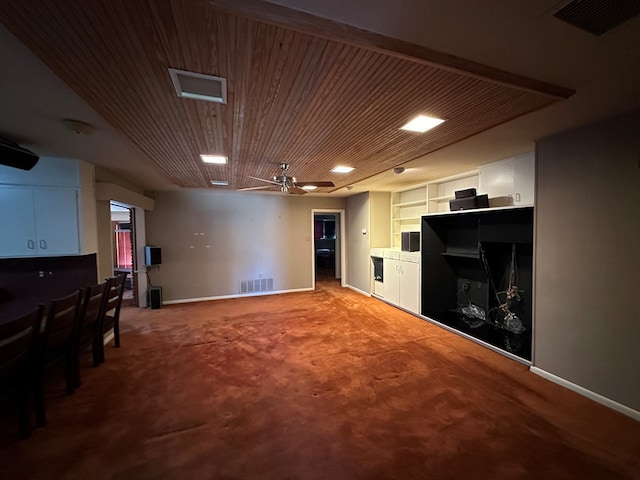 basement featuring carpet and ceiling fan