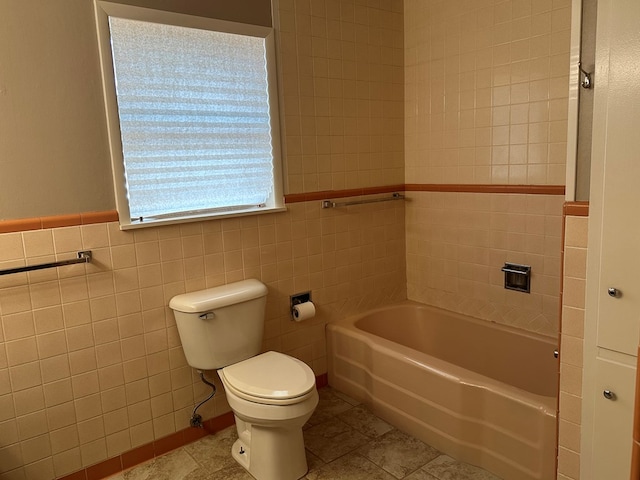 bathroom with tile patterned flooring, tile walls, and toilet