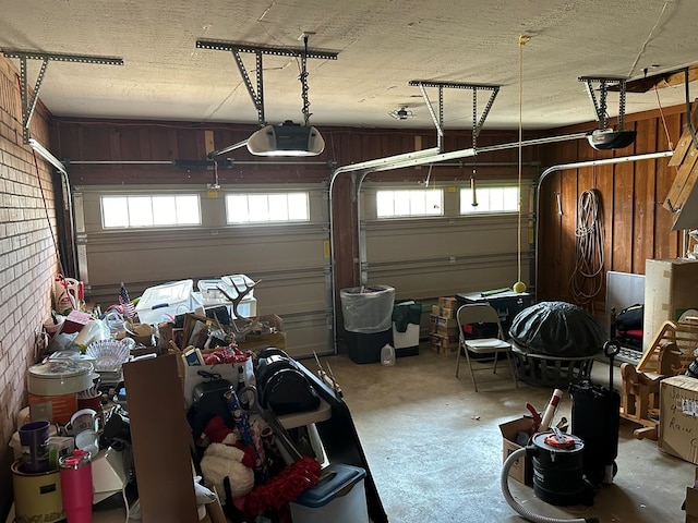 garage featuring wooden walls and a garage door opener