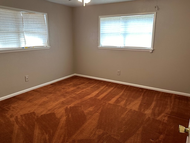 carpeted empty room featuring ceiling fan