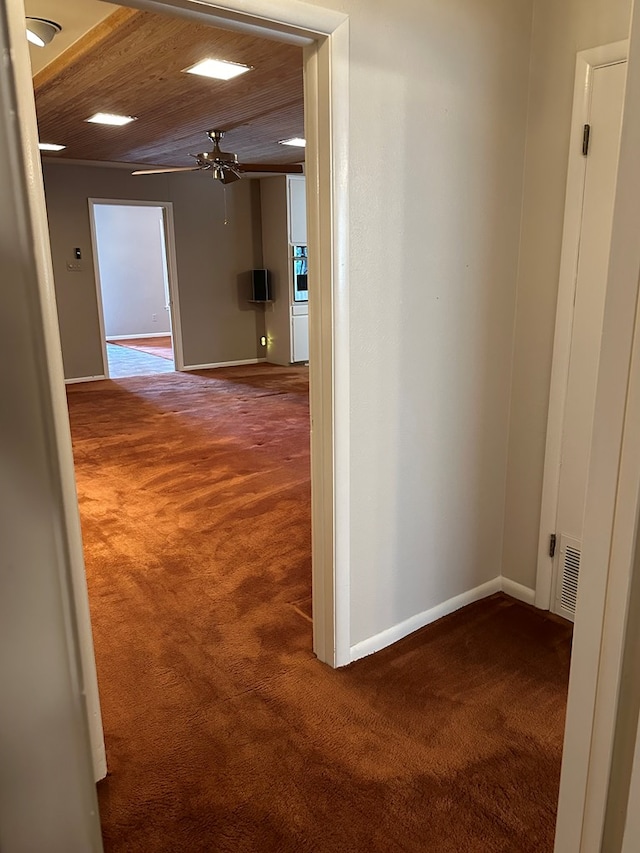 corridor featuring carpet and wood ceiling