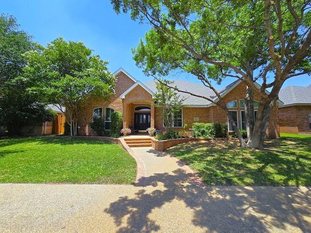 4808 W Cherrywood Ct W, Midland, TX 79707 - traditional-style house with brick siding and a front lawn