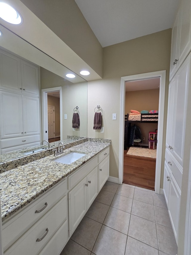 4808 W Cherrywood Ct W, Midland, TX 79707 - bathroom with vanity, tile patterned floors, baseboards, recessed lighting, and a spacious closet