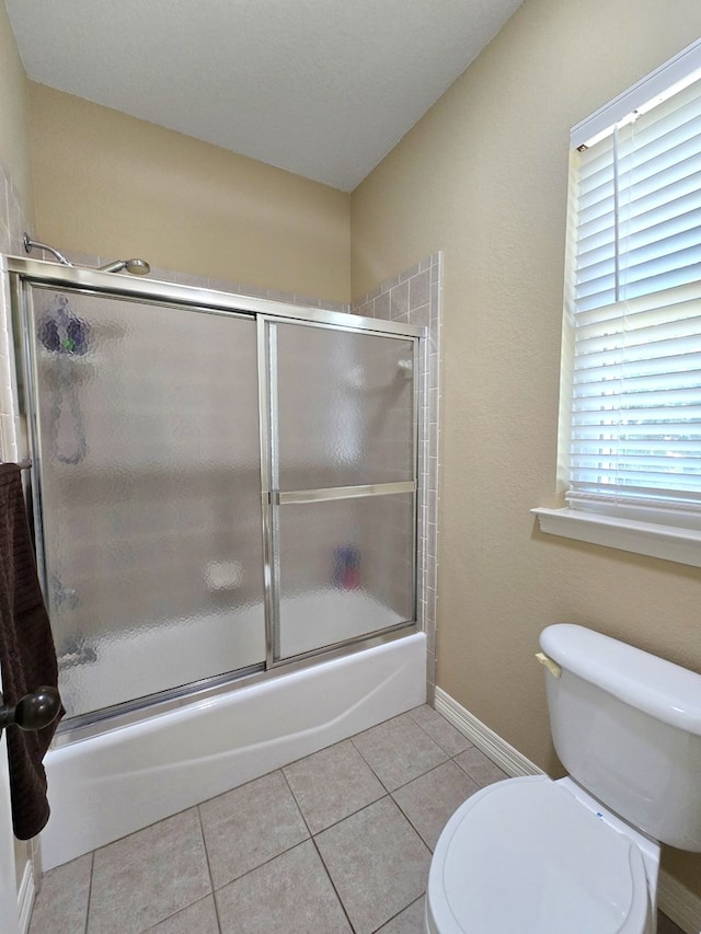 4808 W Cherrywood Ct W, Midland, TX 79707 - full bathroom featuring toilet, combined bath / shower with glass door, tile patterned floors, and baseboards